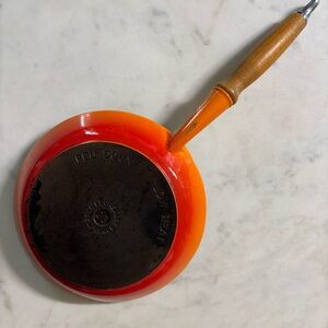 Le Creuset low heat enamelled cast iron skillet with nonstick coating in flame